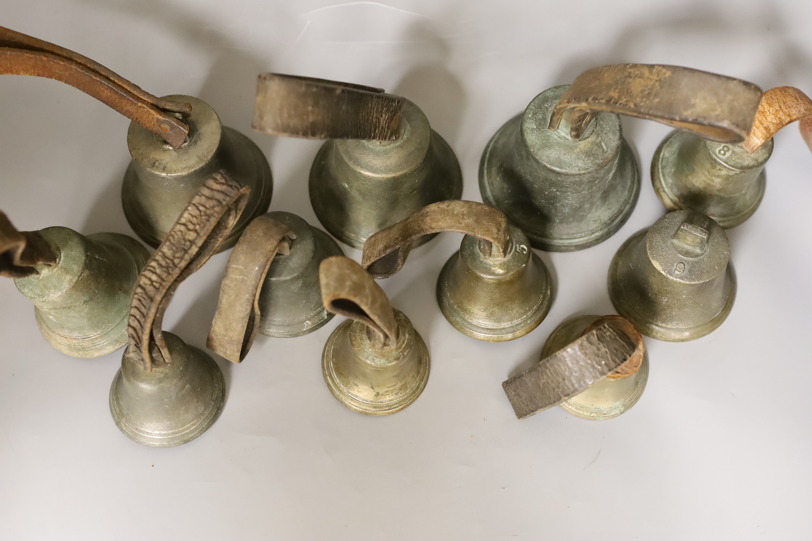 A harlequin set of 11 musical hand bells